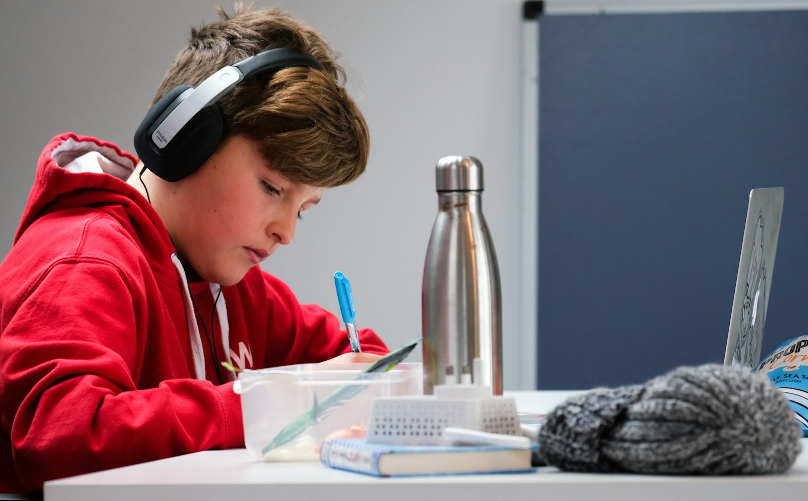 Student in headphones studying on a laptop
