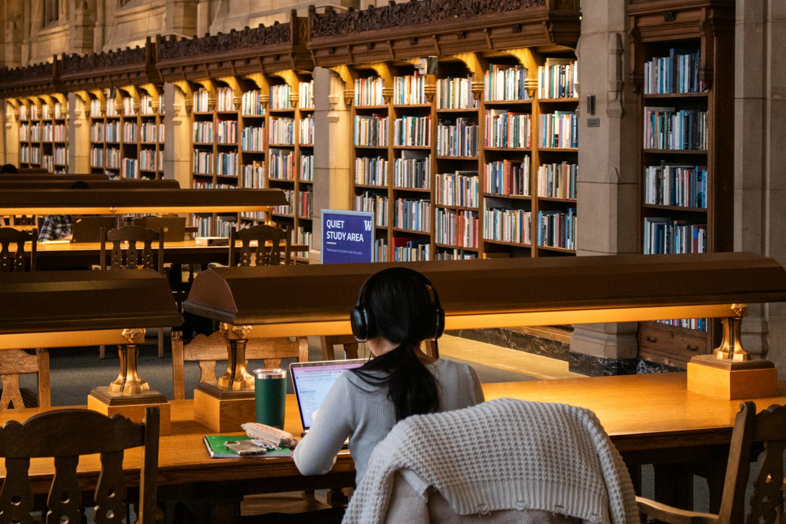 Student working through practice questions in a library