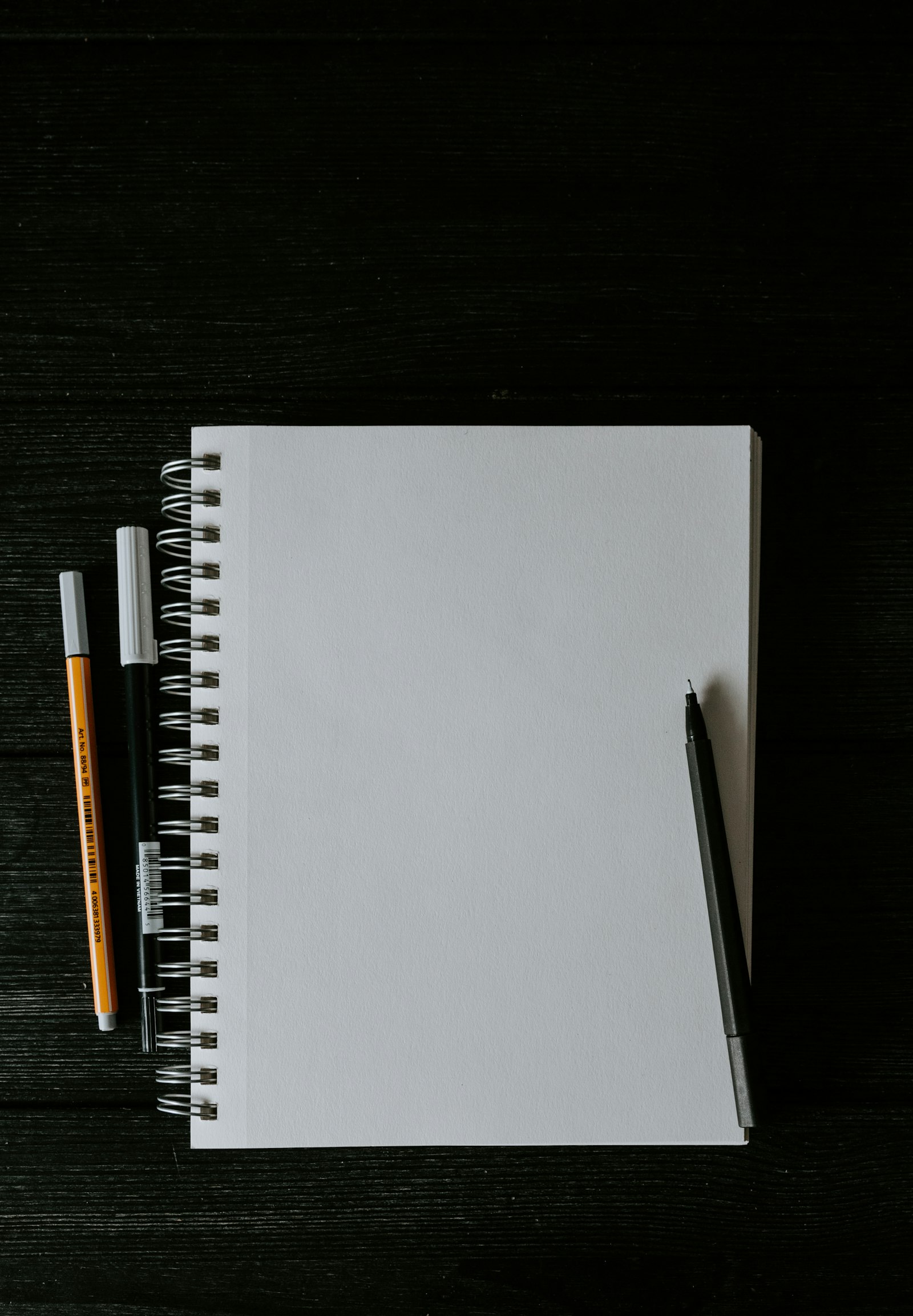 Spiral notebook and an orange pen ready for a blurt