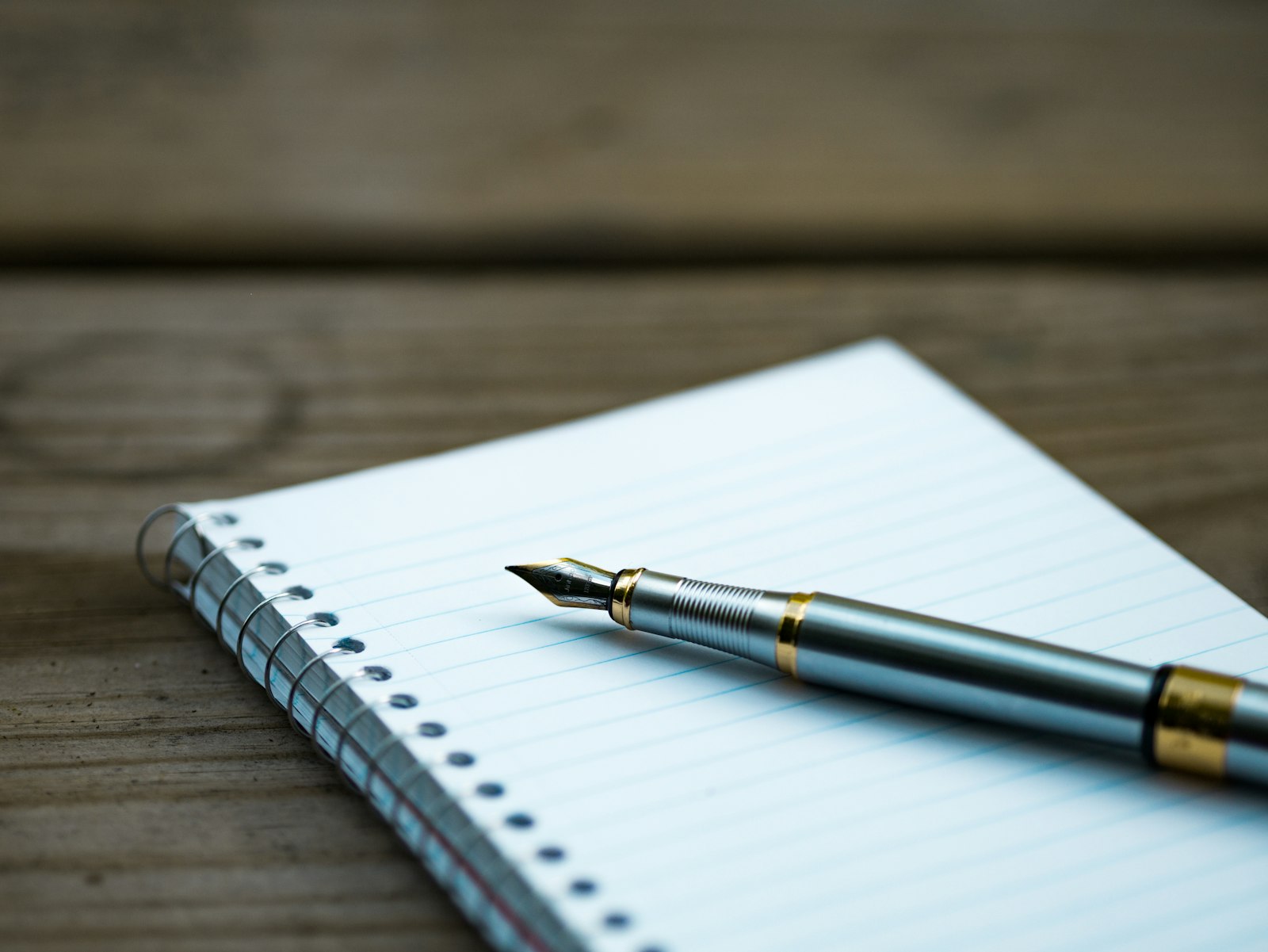 Pen resting on an open blank notebook